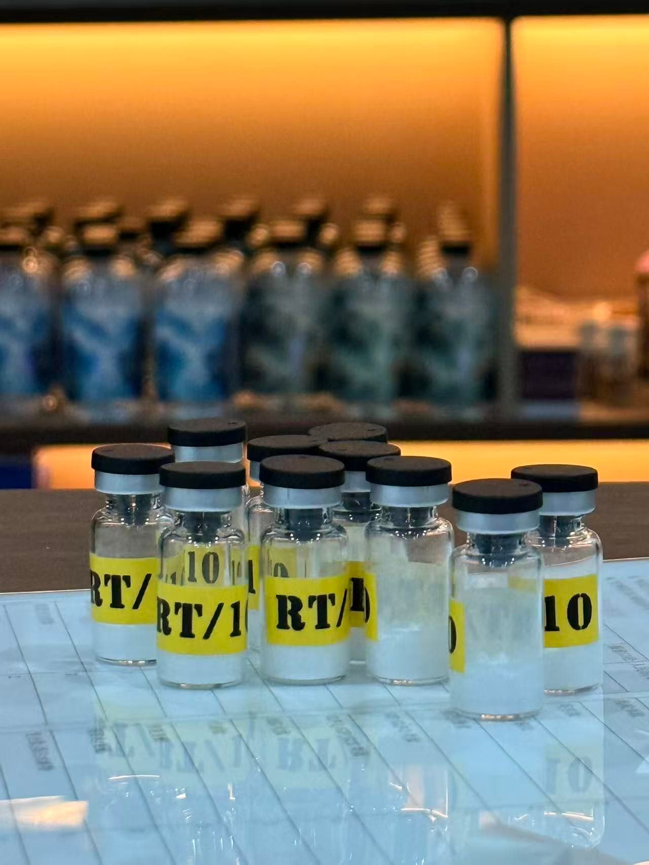 Vialdyne released-batch vials on the QA bench, lyophilized peptide active inside each, after per-lot HPLC and LAL endotoxin testing